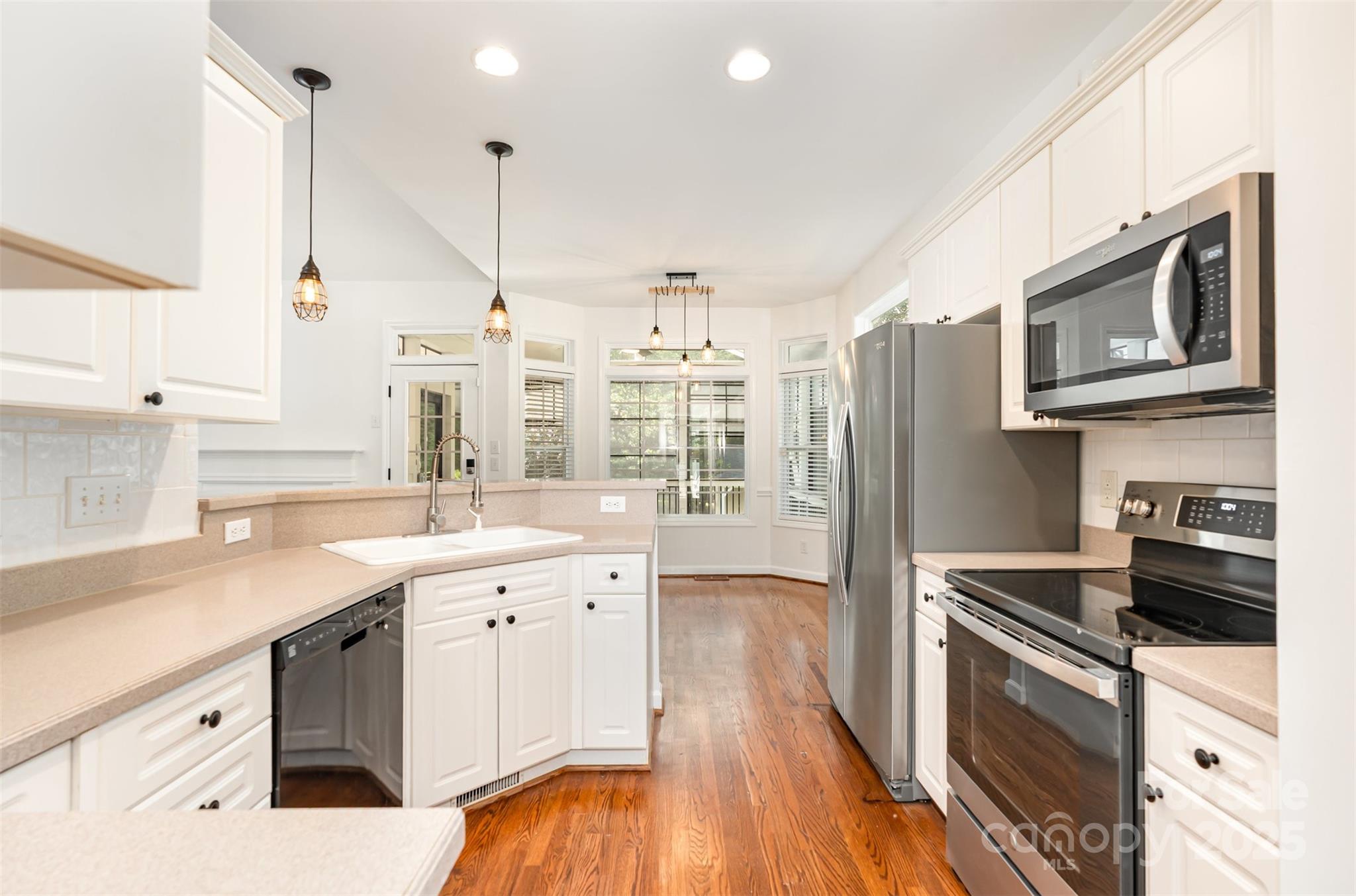 2746 Cameron Commons Way Matthews, NC 28104 - Photo 14 of 38 a kitchen with a sink stove and microwave