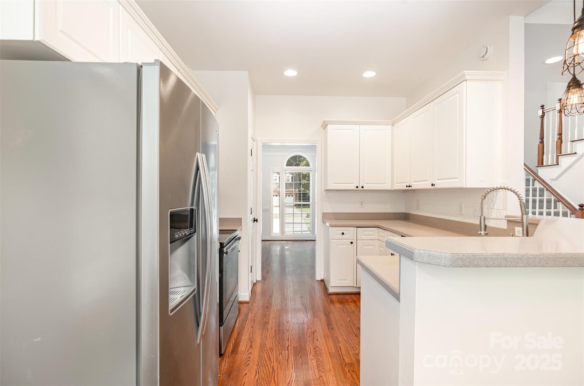 2746 Cameron Commons Way Matthews, NC 28104 - Photo 16 of 38 a kitchen with a refrigerator sink and cabinets