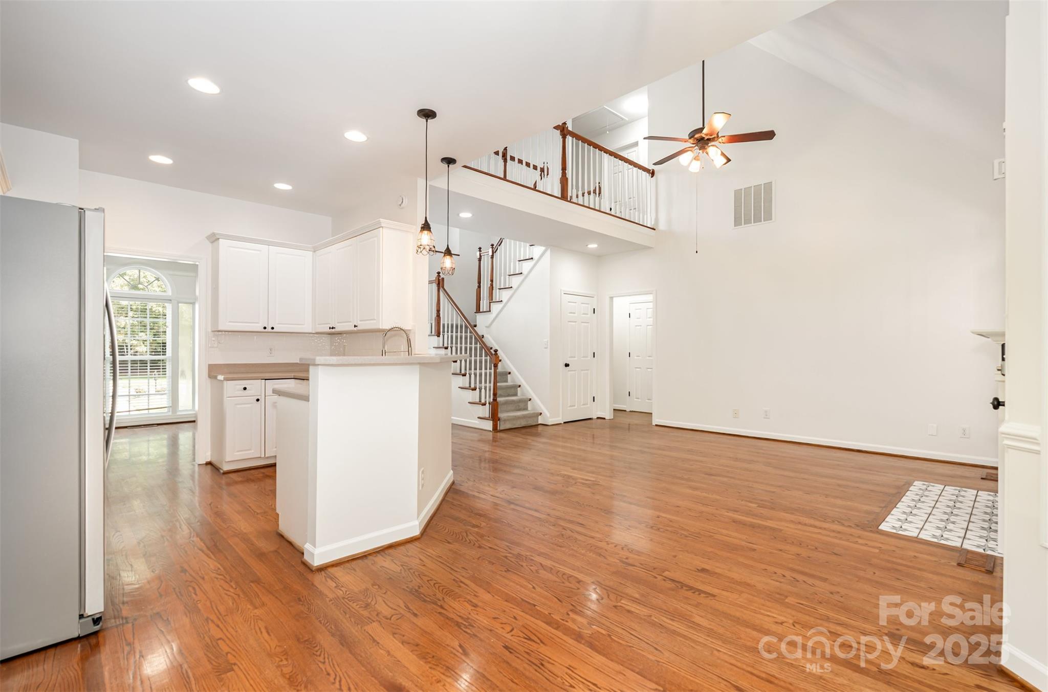 2746 Cameron Commons Way Matthews, NC 28104 - Photo 17 of 38 a view of a kitchen with wooden floor and electronic appliances