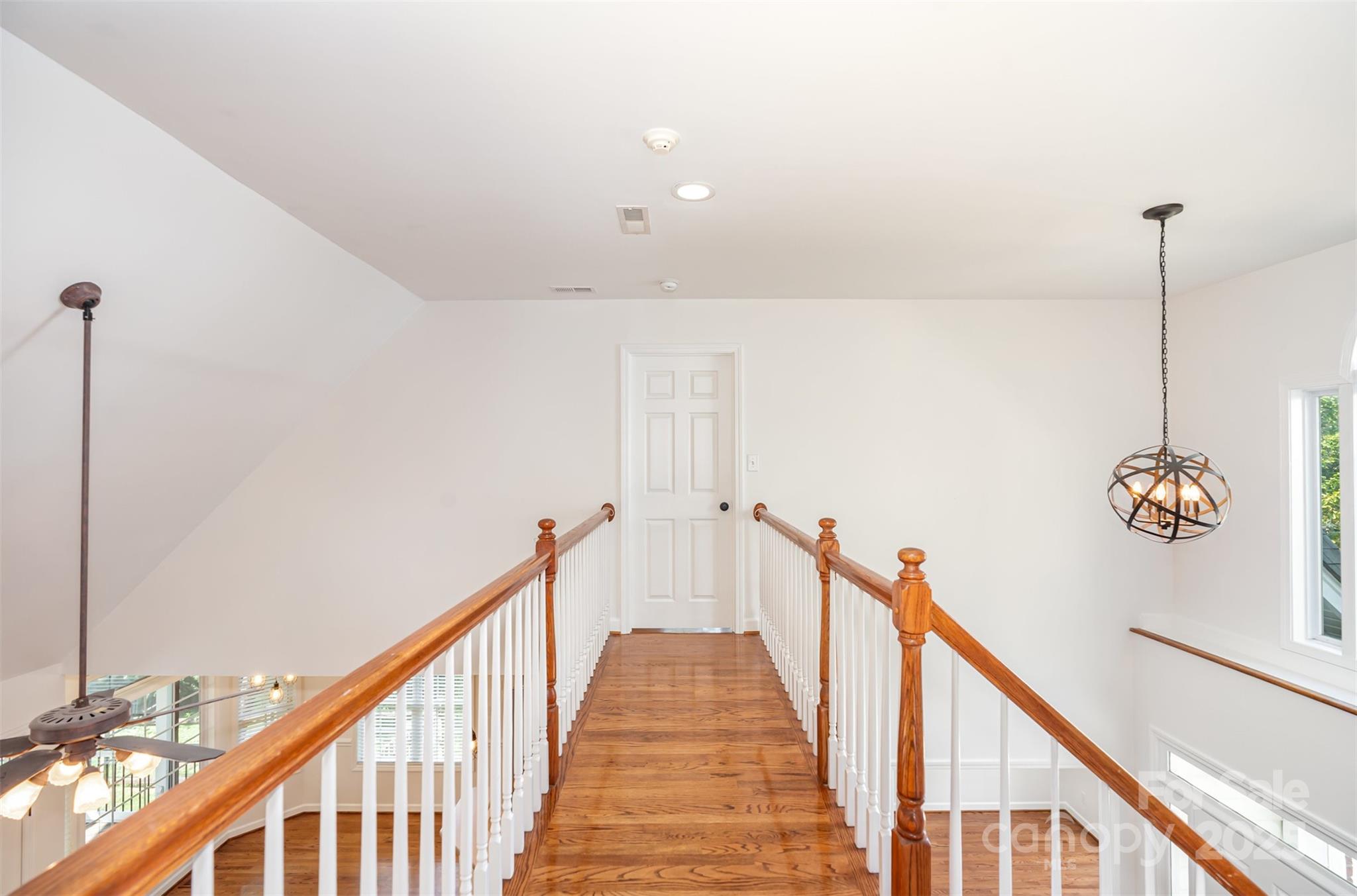 2746 Cameron Commons Way Matthews, NC 28104 - Photo 18 of 38 a view of a hallway with wooden floor and stairs