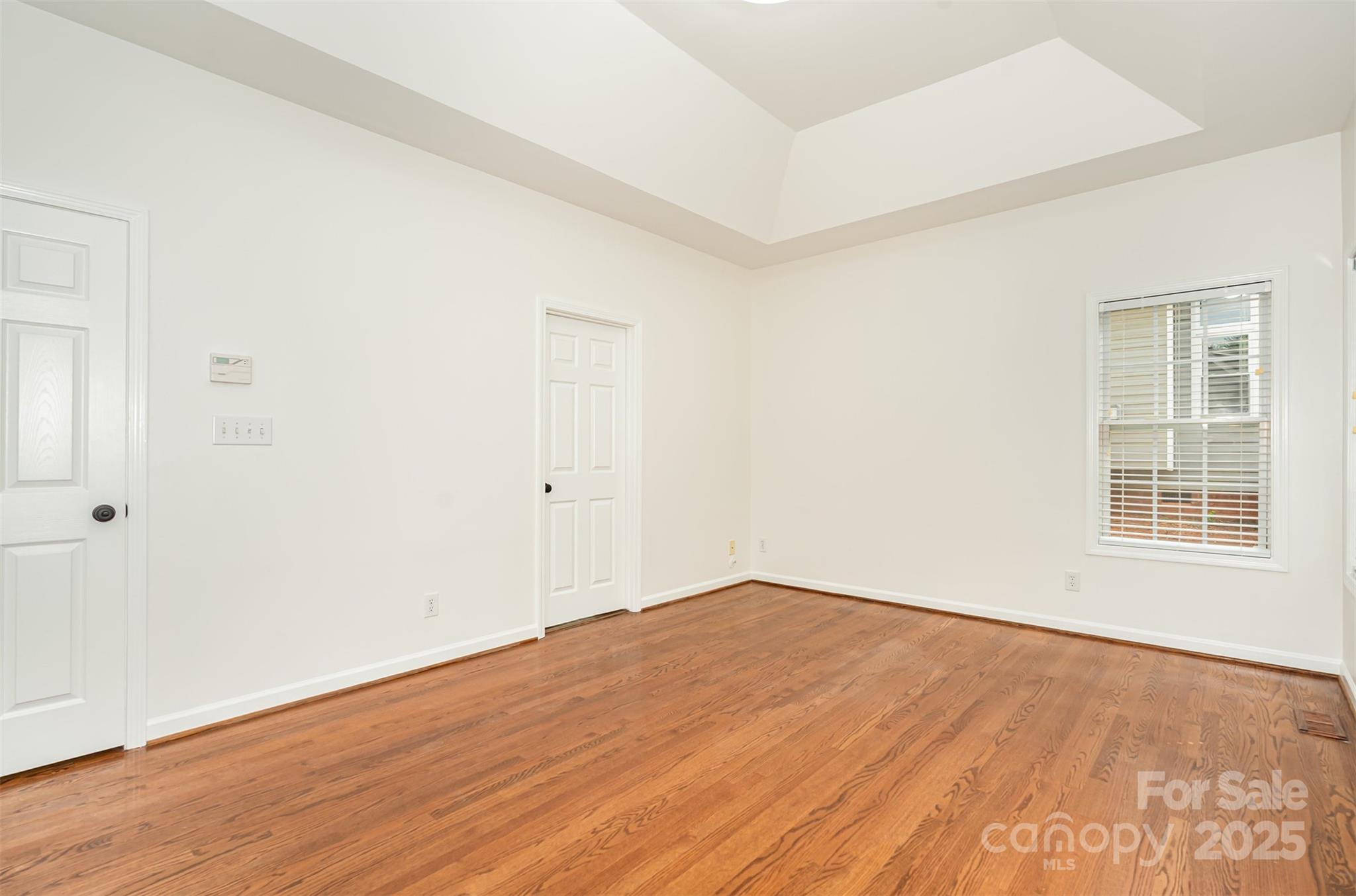 2746 Cameron Commons Way Matthews, NC 28104 - Photo 19 of 38 an empty room with wooden floor and windows