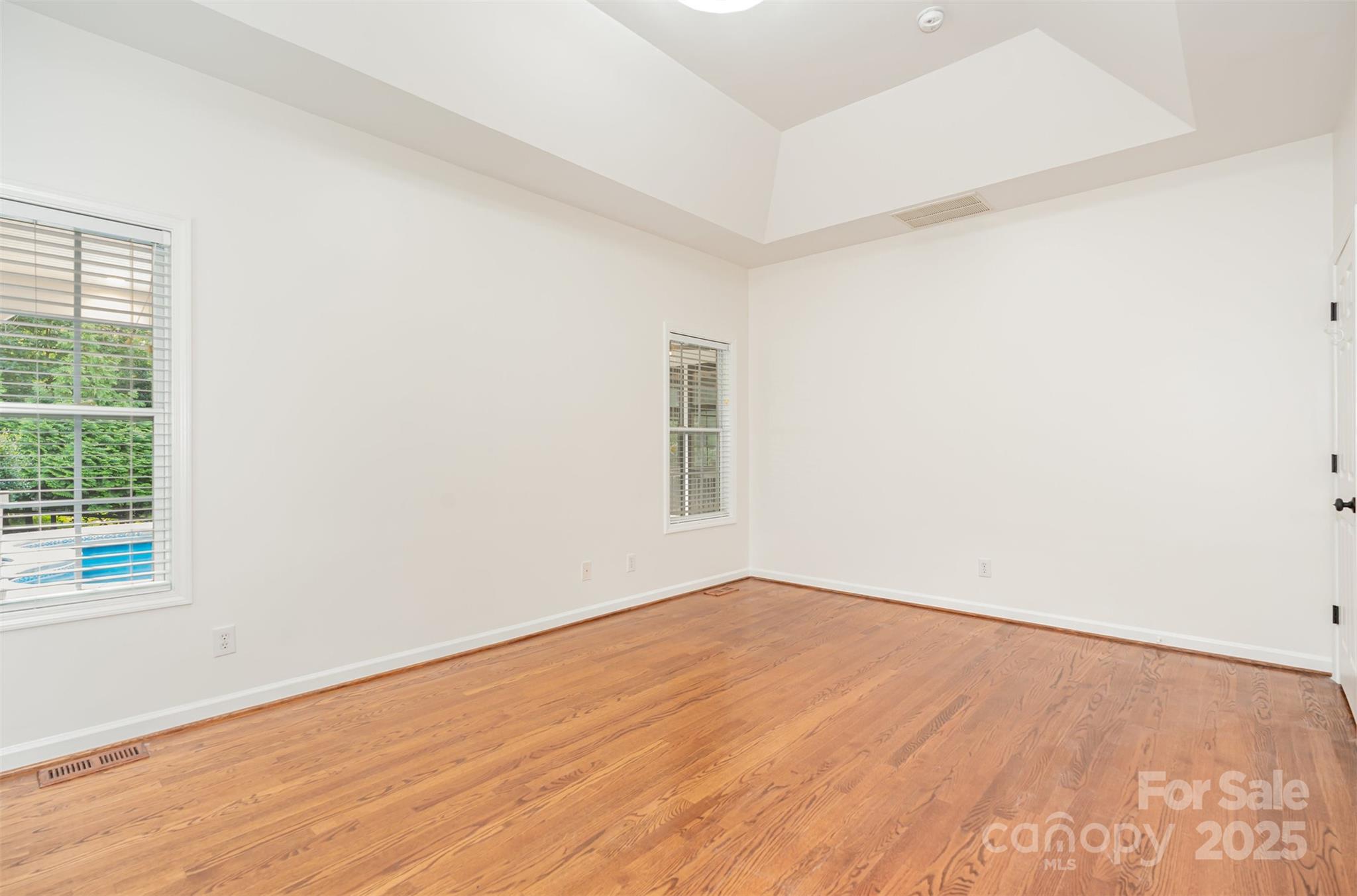 2746 Cameron Commons Way Matthews, NC 28104 - Photo 21 of 38 an empty room with wooden floor and windows