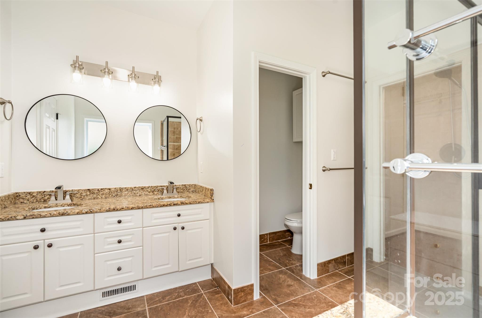 2746 Cameron Commons Way Matthews, NC 28104 - Photo 22 of 38 a bathroom with a double vanity sink and a mirror