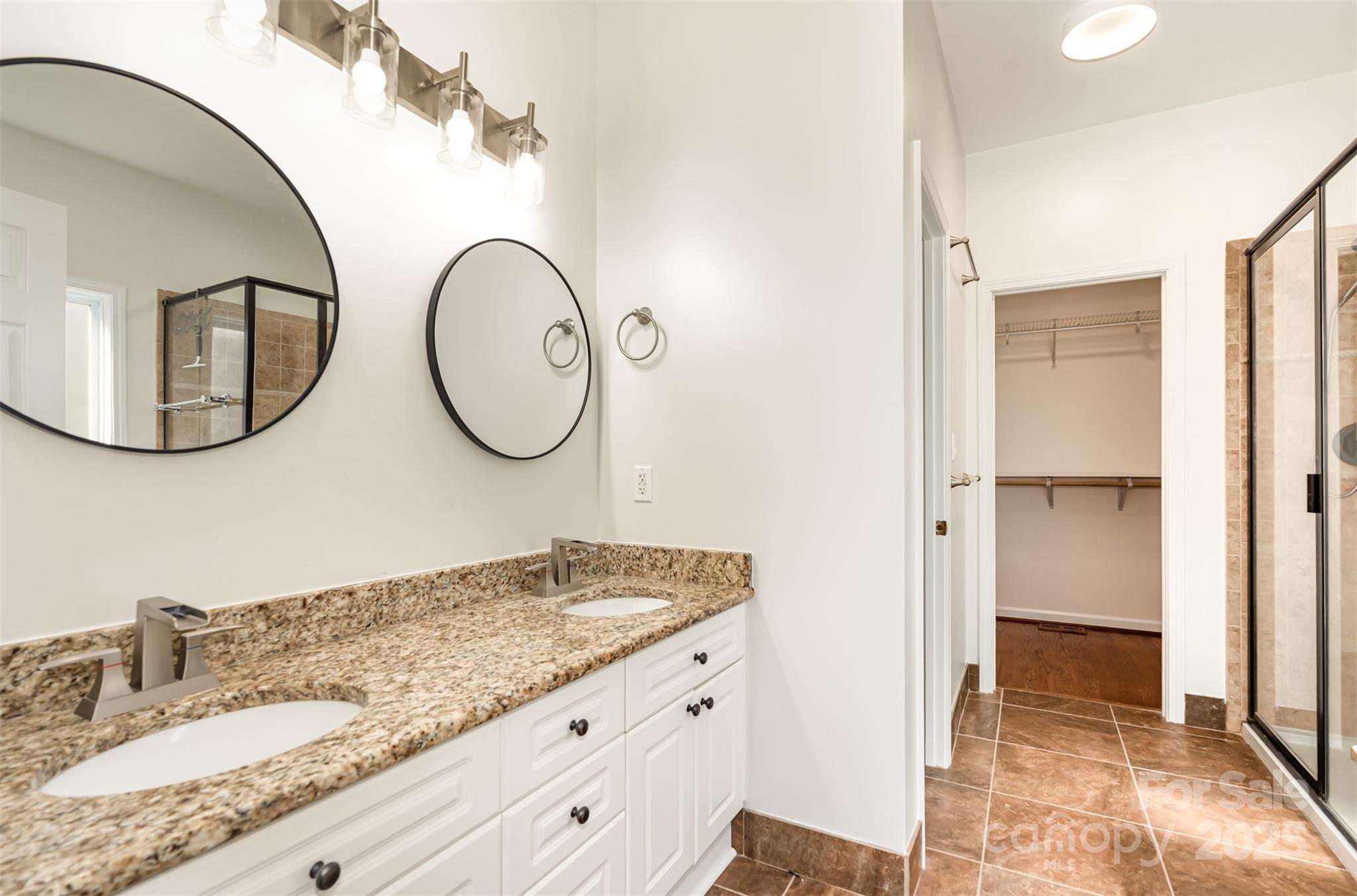 2746 Cameron Commons Way Matthews, NC 28104 - Photo 23 of 38 a bathroom with a granite countertop double vanity sink and a mirror