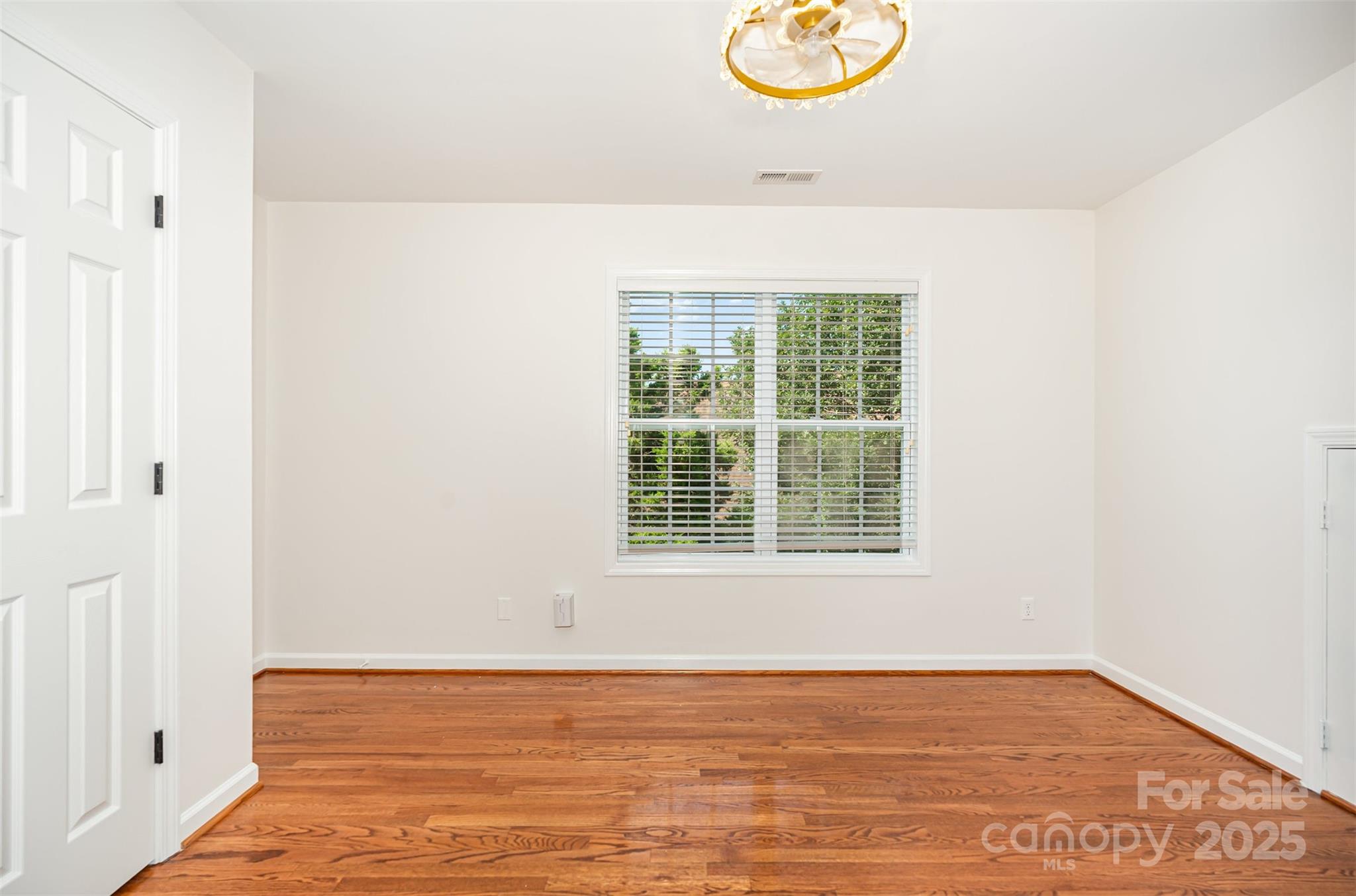 2746 Cameron Commons Way Matthews, NC 28104 - Photo 26 of 38 a view of an empty room with wooden floor and a window