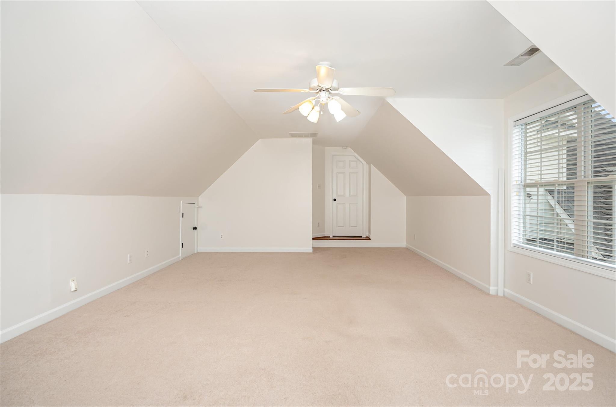 2746 Cameron Commons Way Matthews, NC 28104 - Photo 29 of 38 an empty room with chandelier fan and windows