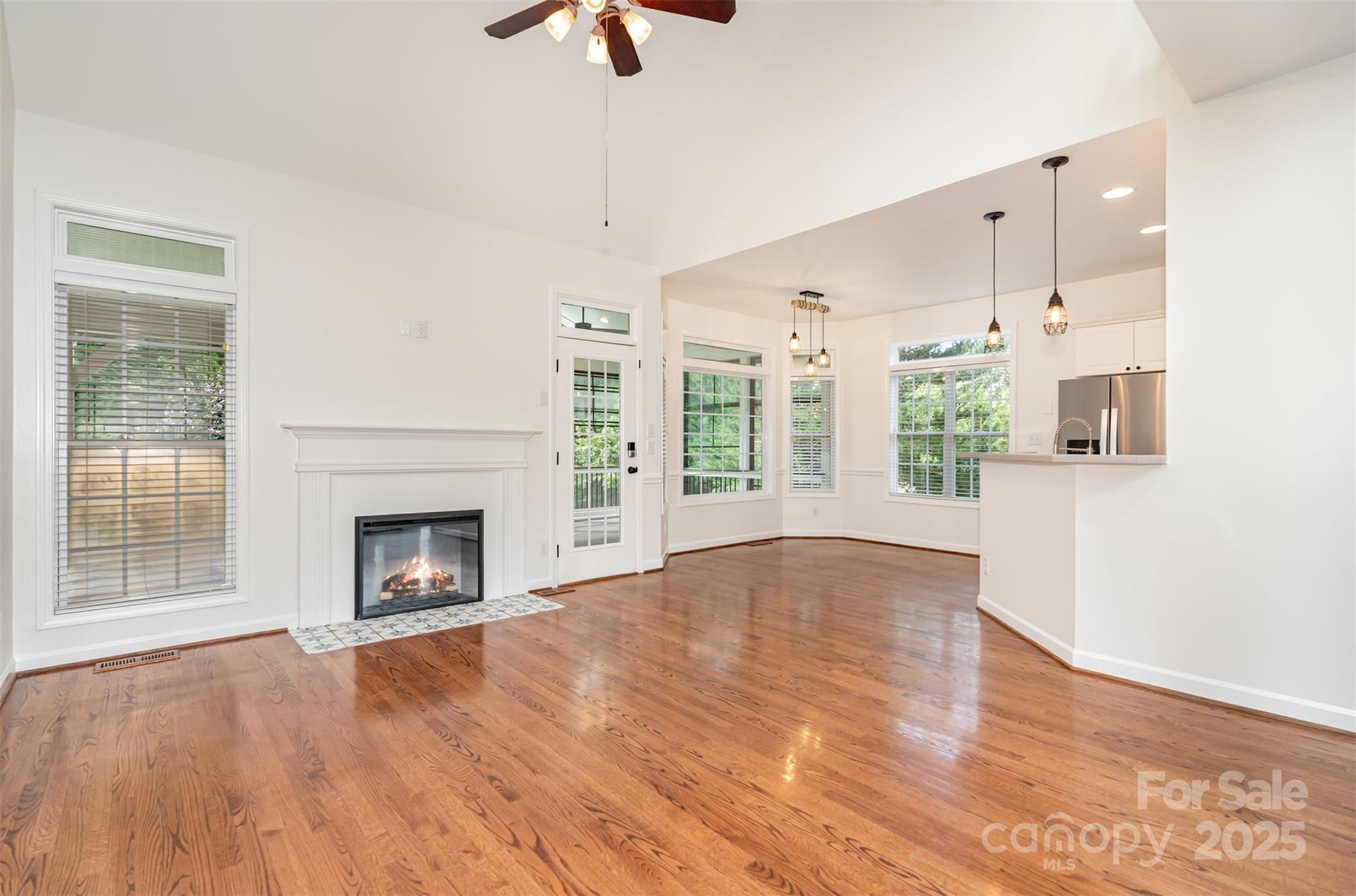 2746 Cameron Commons Way Matthews, NC 28104 - Photo 7 of 38 a view of an empty room with wooden floor fireplace and a window