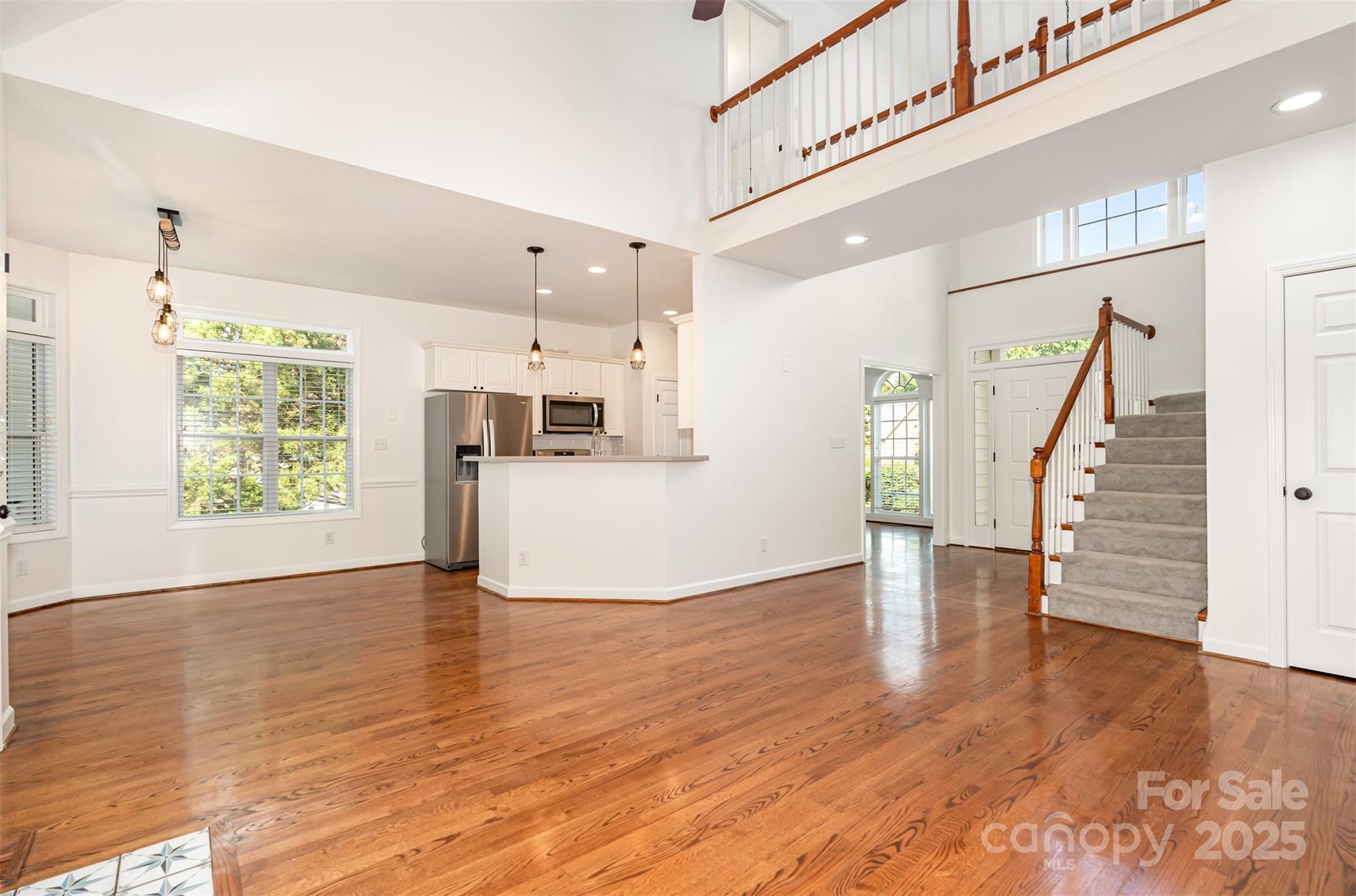 2746 Cameron Commons Way Matthews, NC 28104 - Photo 9 of 38 a view of a kitchen with furniture and wooden floor