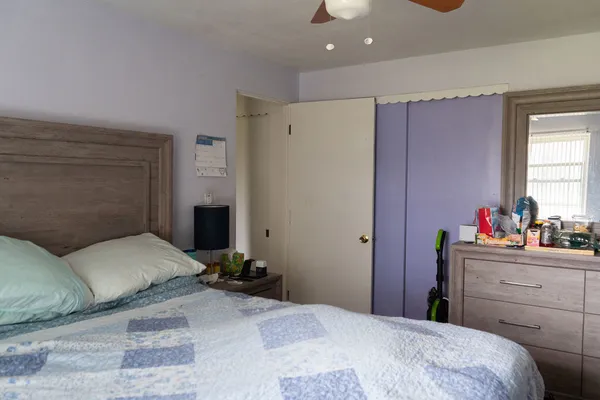 a bedroom with a bed and a dresser