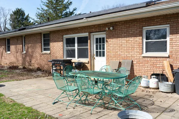 a view of a chair and table in the patio
