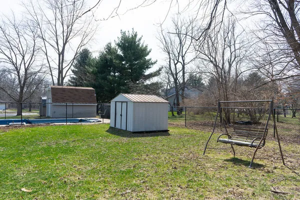a view of a backyard and a tree