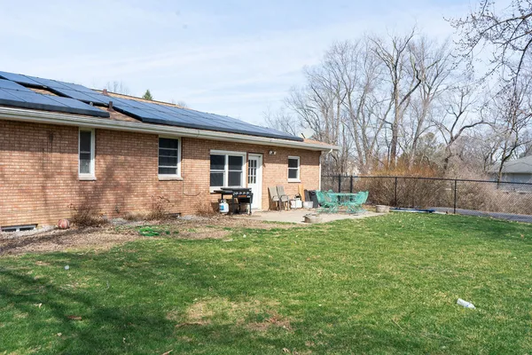 a view of a house with backyard and sitting area