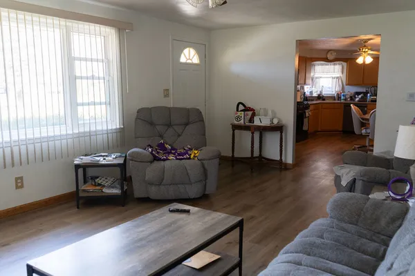 a living room with furniture and wooden floor