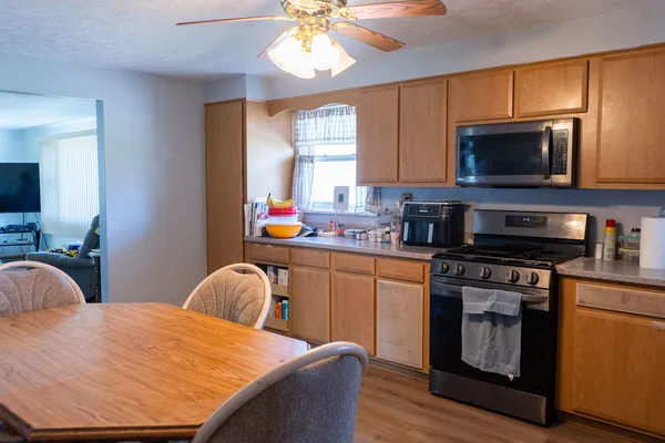 a kitchen with a stove a sink and a microwave
