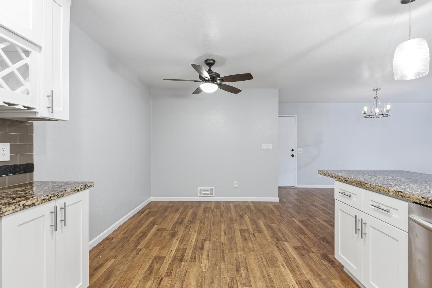 1416 Buttonwillow Drive Modesto, CA 95355 - Photo 12 of 39 wooden floor in an empty room with a stove