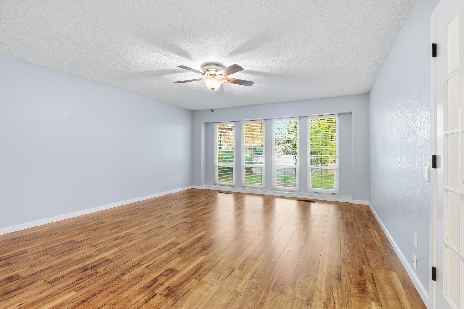 1416 Buttonwillow Drive Modesto, CA 95355 - Photo 14 of 39 a view of empty room with wooden floor and fan