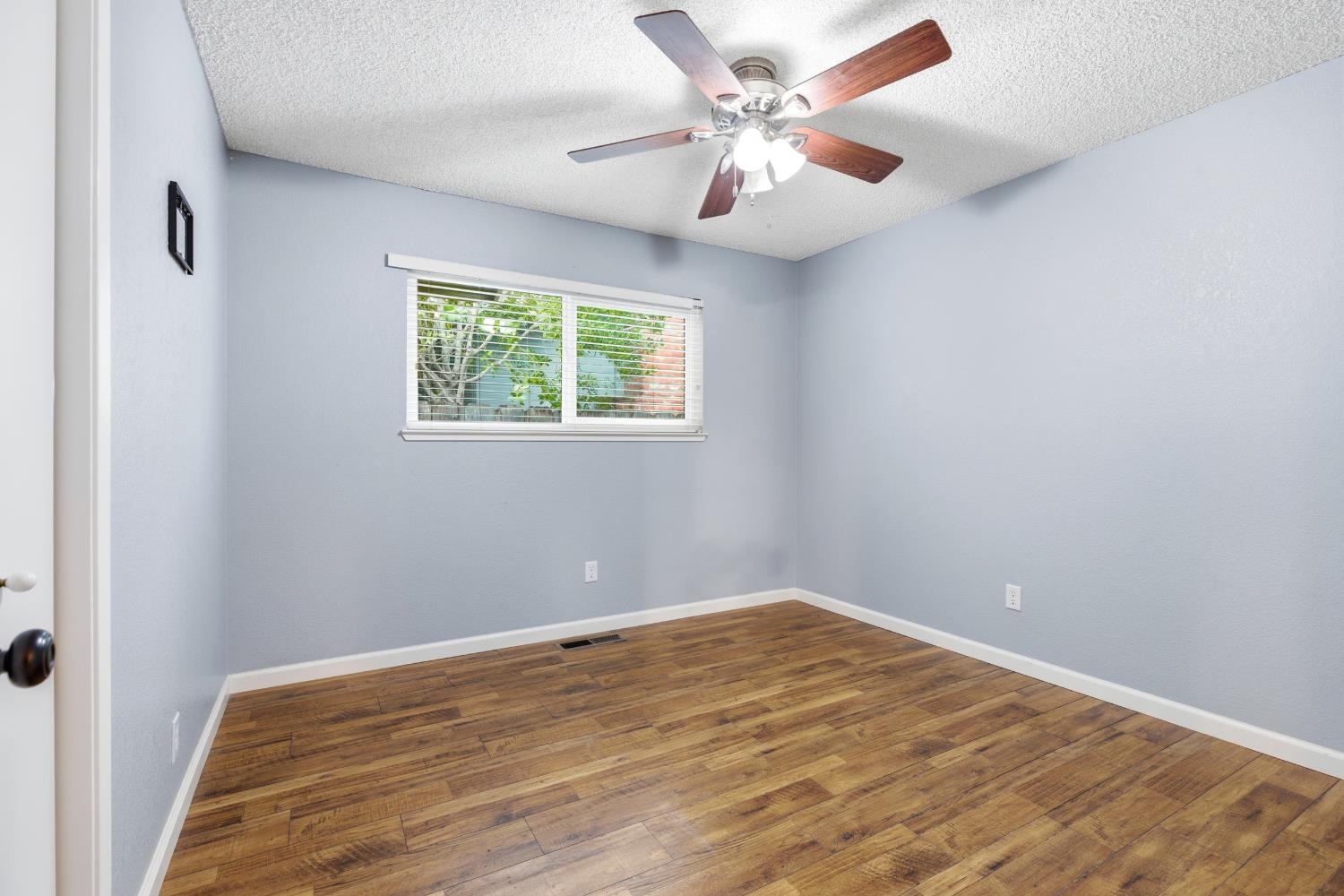 1416 Buttonwillow Drive Modesto, CA 95355 - Photo 17 of 39 an empty room with a window and a ceiling fan