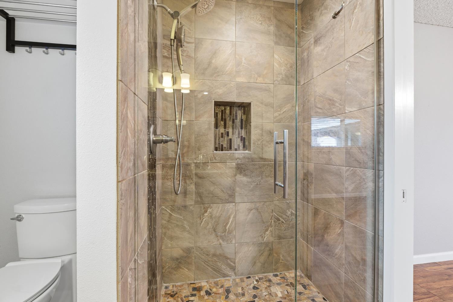 1416 Buttonwillow Drive Modesto, CA 95355 - Photo 25 of 39 a bathroom with a glass shower door