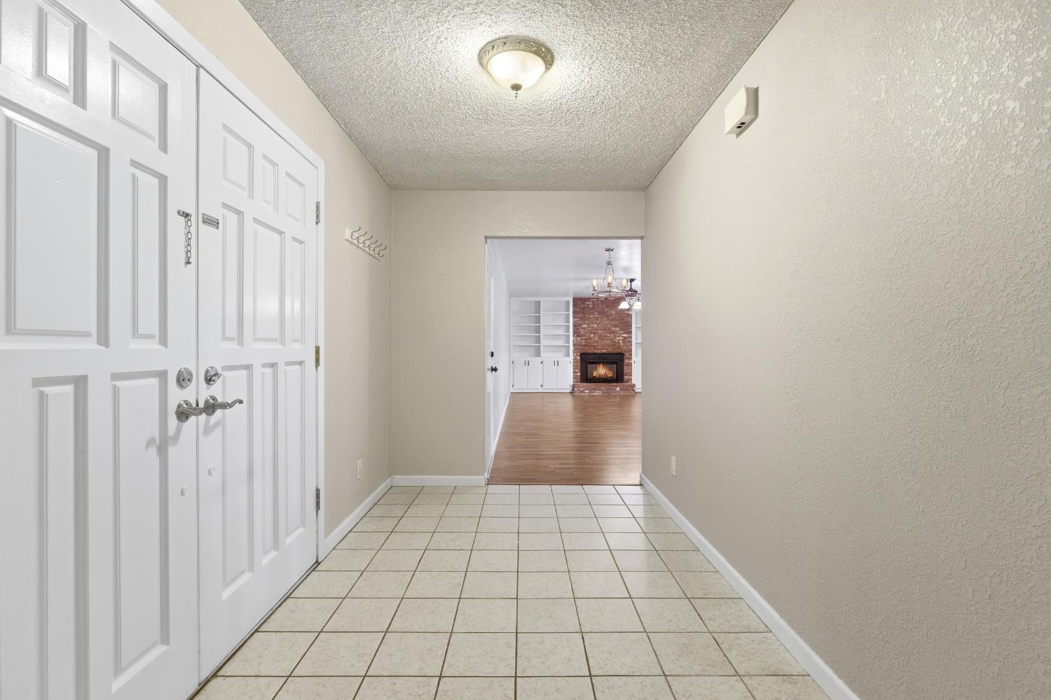 1416 Buttonwillow Drive Modesto, CA 95355 - Photo 3 of 39 a view of a hallway with wooden floor and staircase