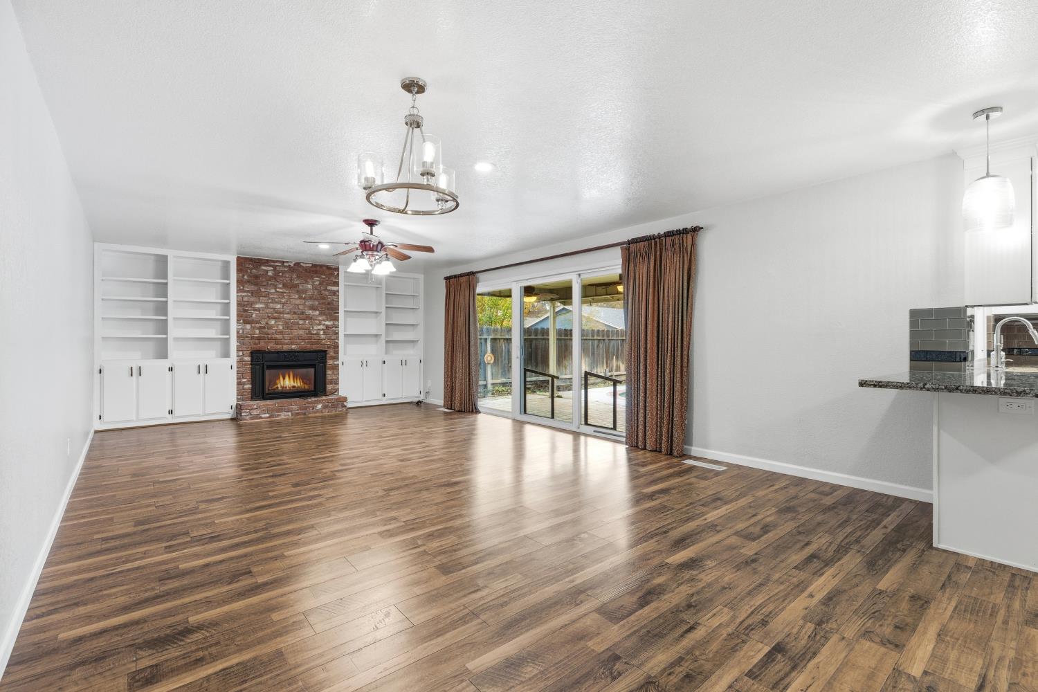 1416 Buttonwillow Drive Modesto, CA 95355 - Photo 4 of 39 wooden floor in an empty room with a window