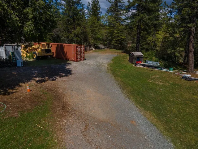 a backyard of a house with table and chairs