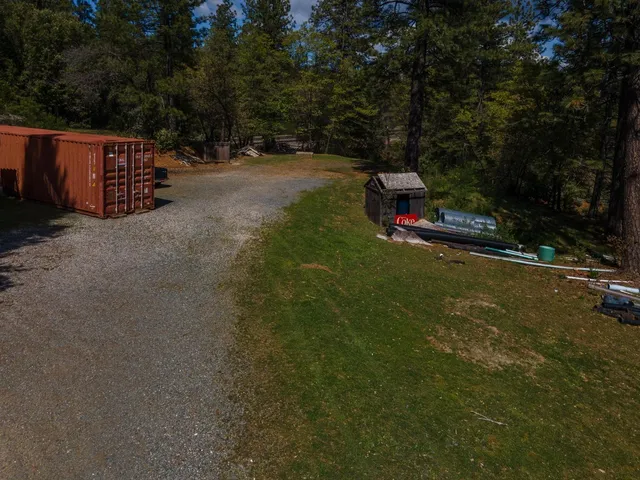 an aerial view of a house with garden space and street view