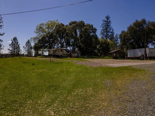 a view of a field of grass and trees