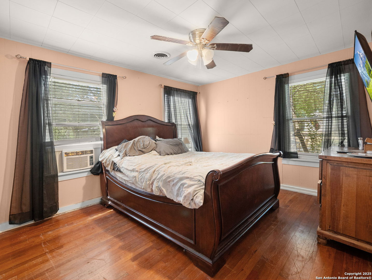 608 Ross Street Kerrville, TX 78028 - Photo 11 of 24 a bedroom with a large bed and a large window