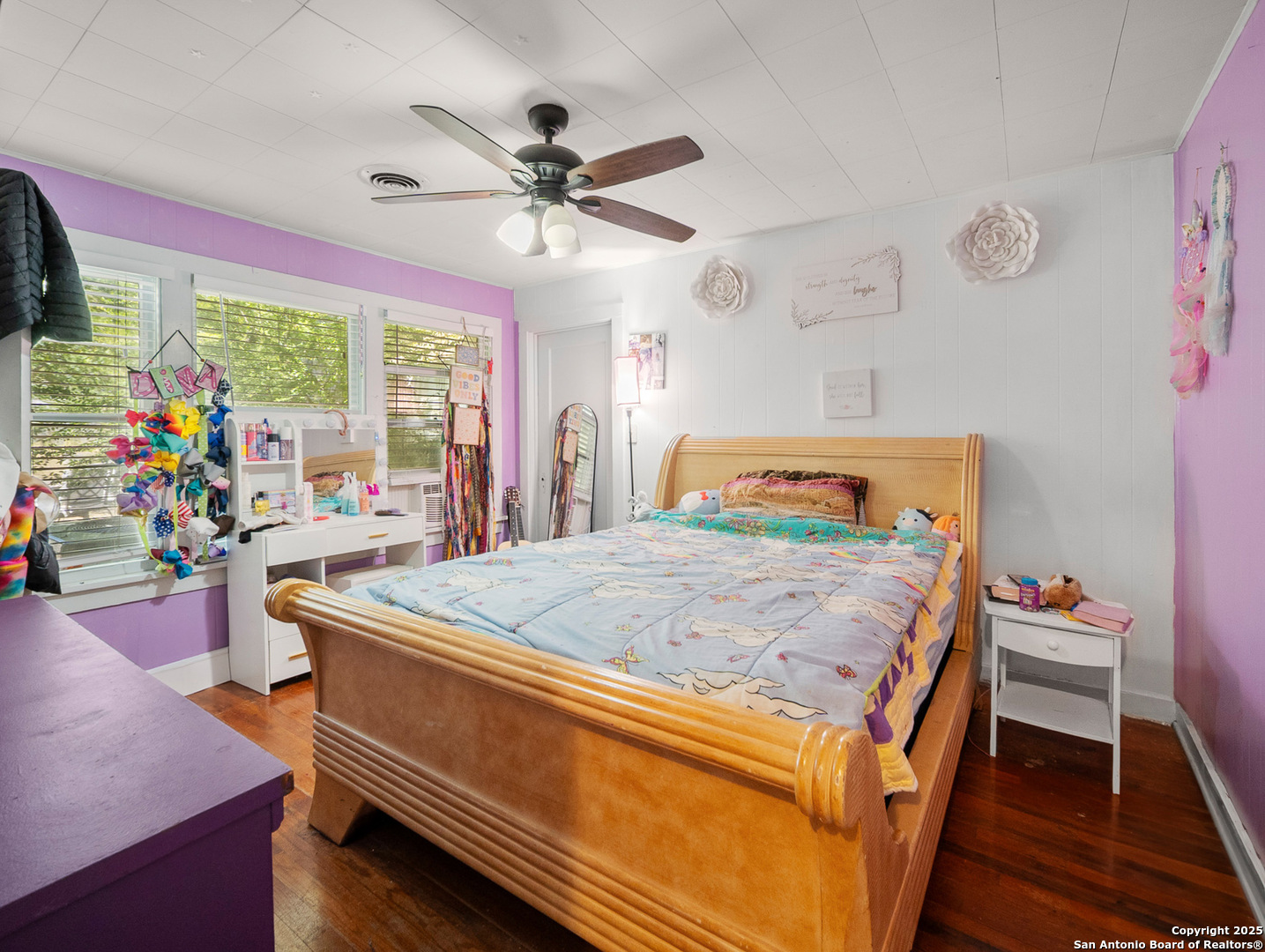608 Ross Street Kerrville, TX 78028 - Photo 13 of 24 a bedroom with a bed and a chandelier
