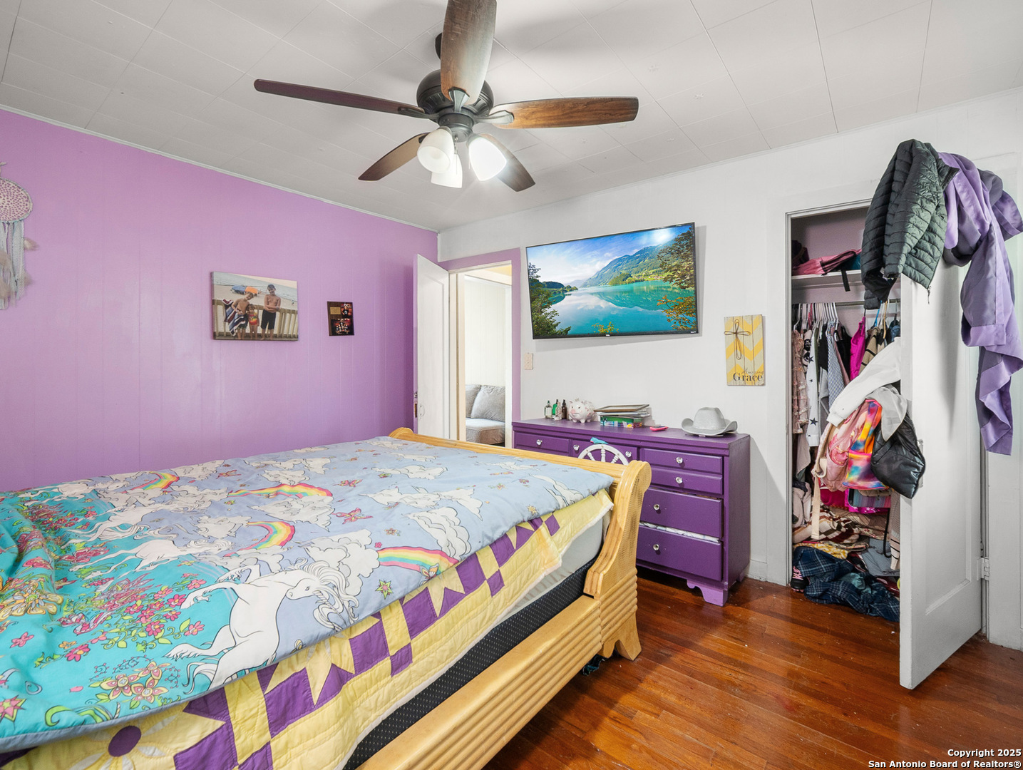 608 Ross Street Kerrville, TX 78028 - Photo 14 of 24 a bedroom with a bed and a chandelier