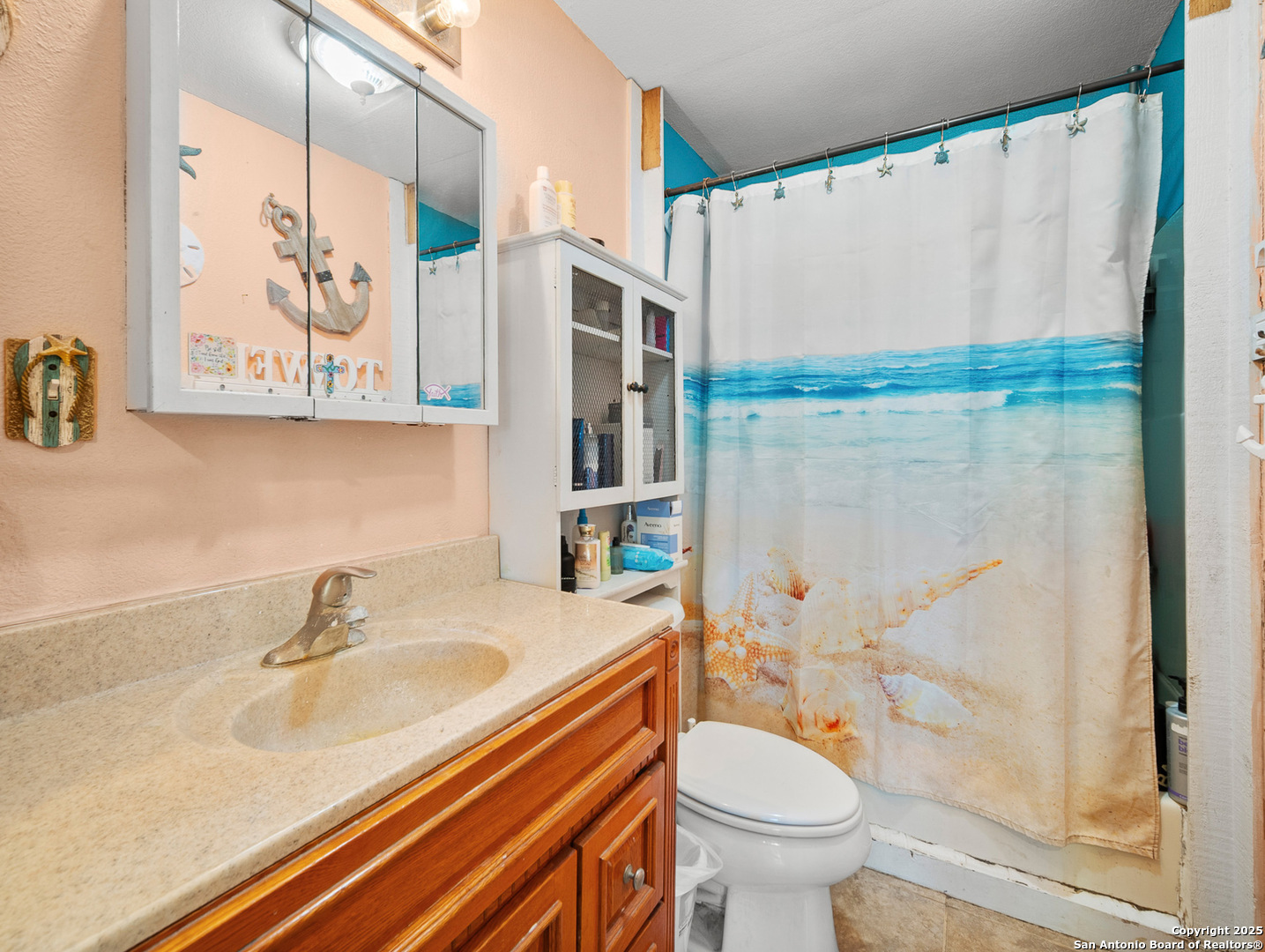 608 Ross Street Kerrville, TX 78028 - Photo 17 of 24 a bathroom with a sink a toilet and shower curtain