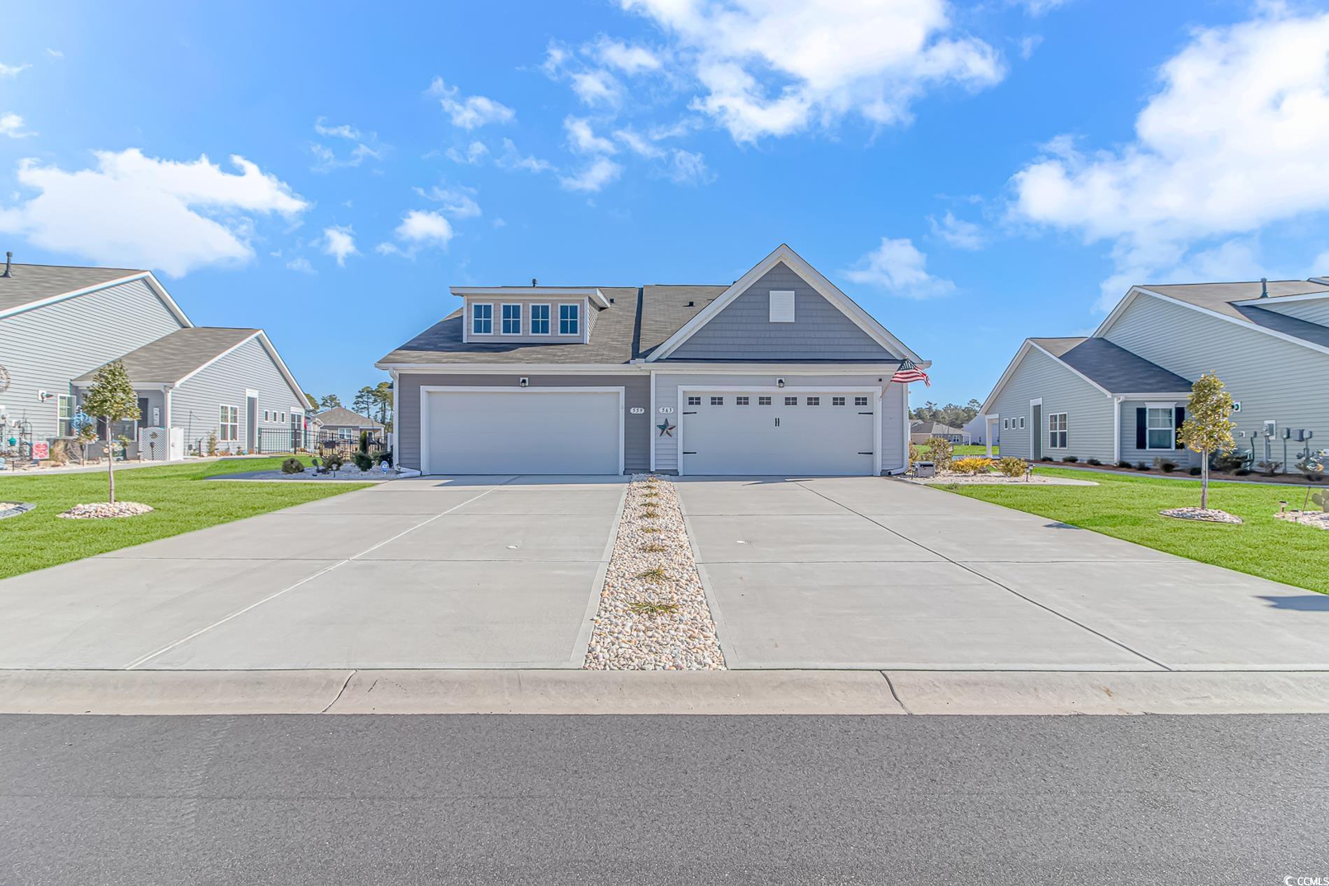 Craftsman-style house featuring a garage and a front lawn