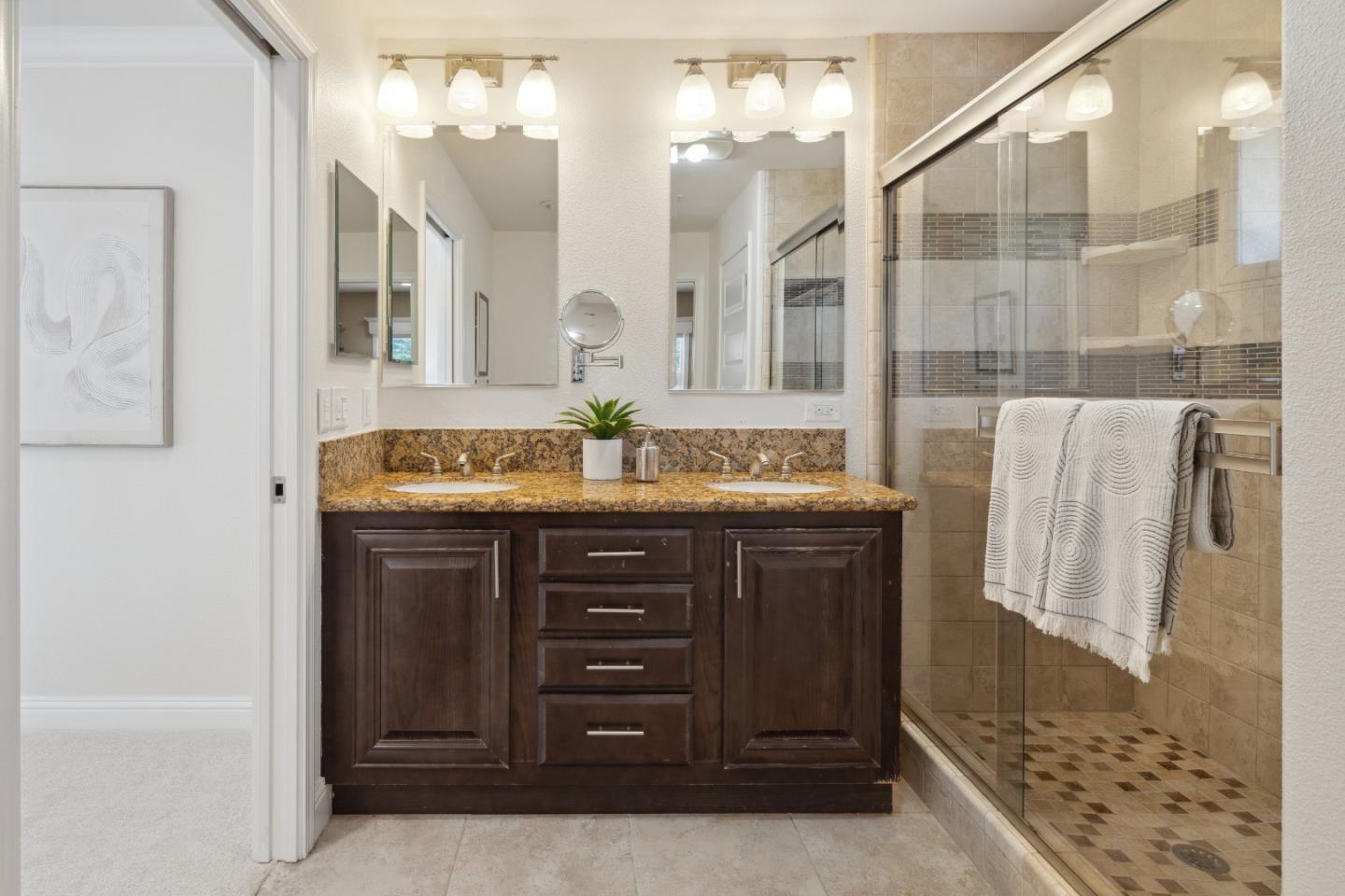24475 Mountain Charlie Road Los Gatos, CA 95033 - Photo 19 of 69 a bathroom with a granite countertop sink a mirror and a shower