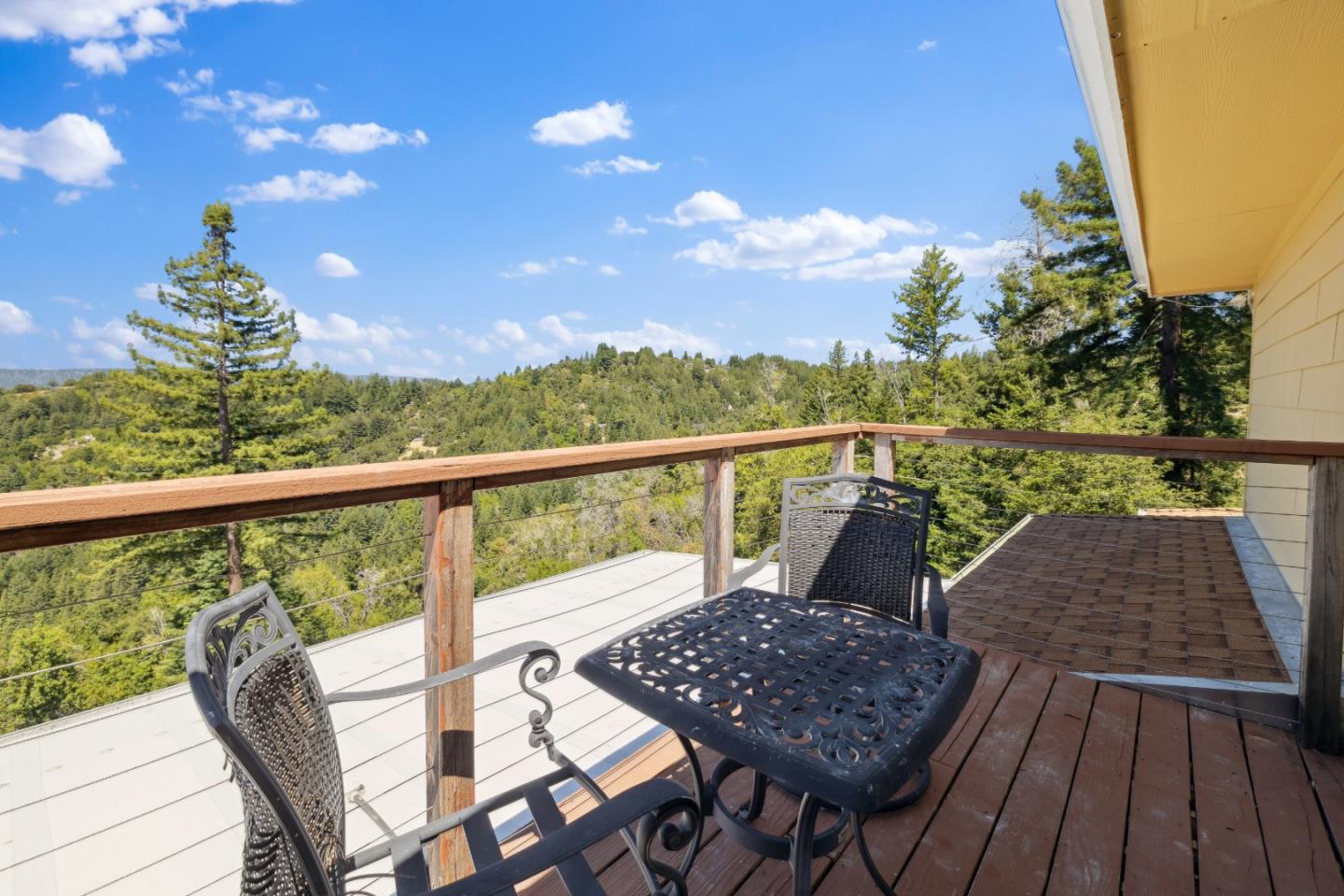 24475 Mountain Charlie Road Los Gatos, CA 95033 - Photo 21 of 69 a view of a balcony with wooden floor and outdoor seating