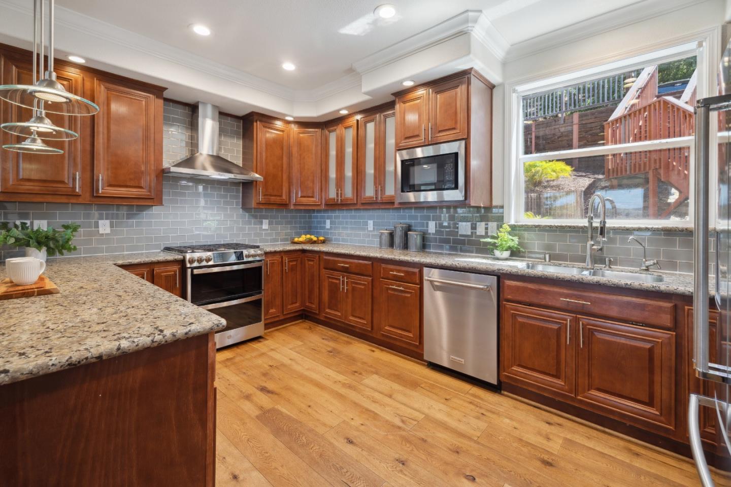 24475 Mountain Charlie Road Los Gatos, CA 95033 - Photo 7 of 69 a kitchen with stainless steel appliances granite countertop wooden cabinets a sink and dishwasher