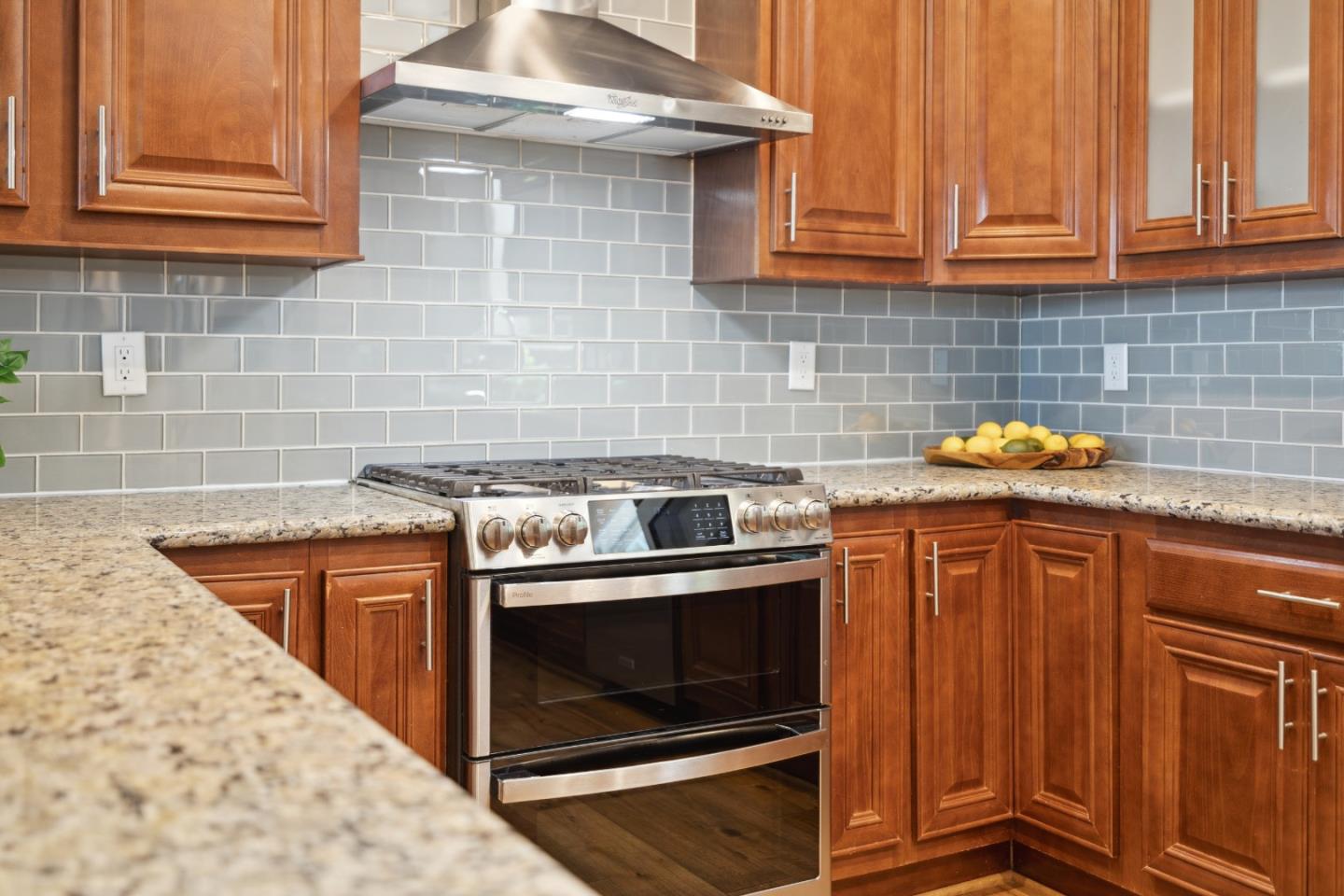24475 Mountain Charlie Road Los Gatos, CA 95033 - Photo 8 of 69 a kitchen with granite countertop a stove top oven a sink dishwasher and cabinets