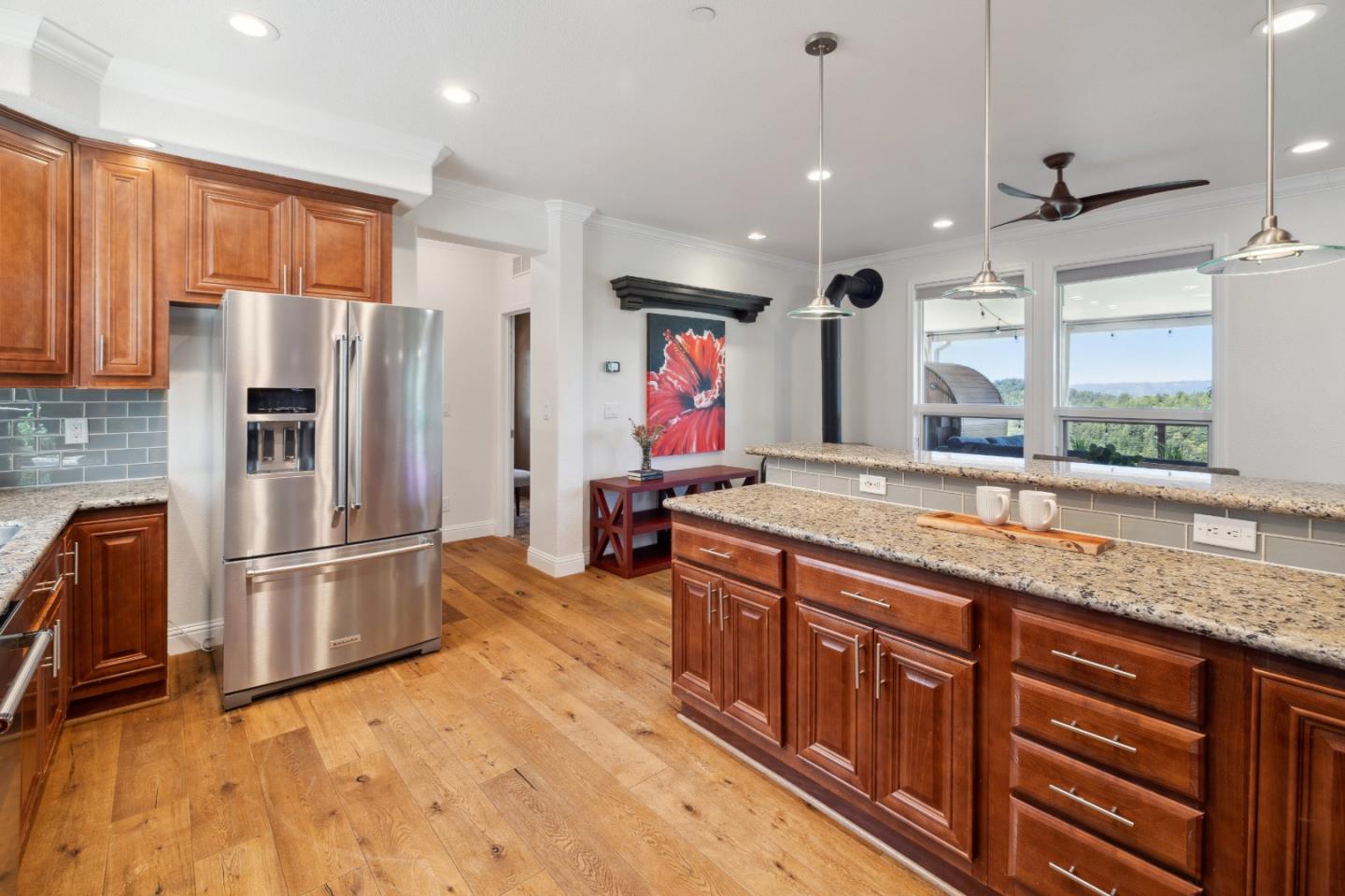 24475 Mountain Charlie Road Los Gatos, CA 95033 - Photo 9 of 69 a kitchen with stainless steel appliances granite countertop a refrigerator a stove and a sink