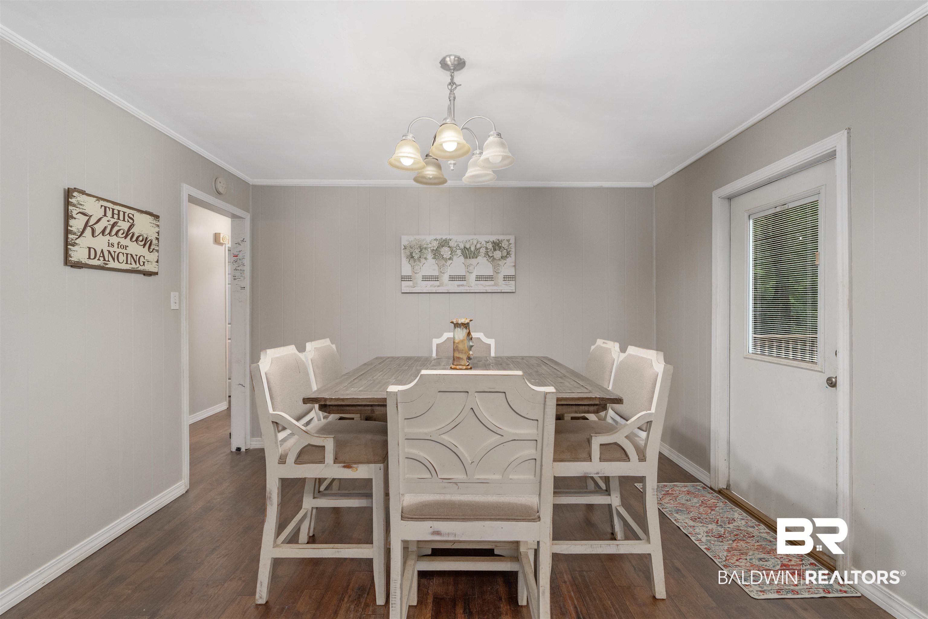 922 Dauphine Circle Daphne, AL 36526 - Photo 2 of 29 Dining space with dark wood-style flooring, a chandelier, and crown molding