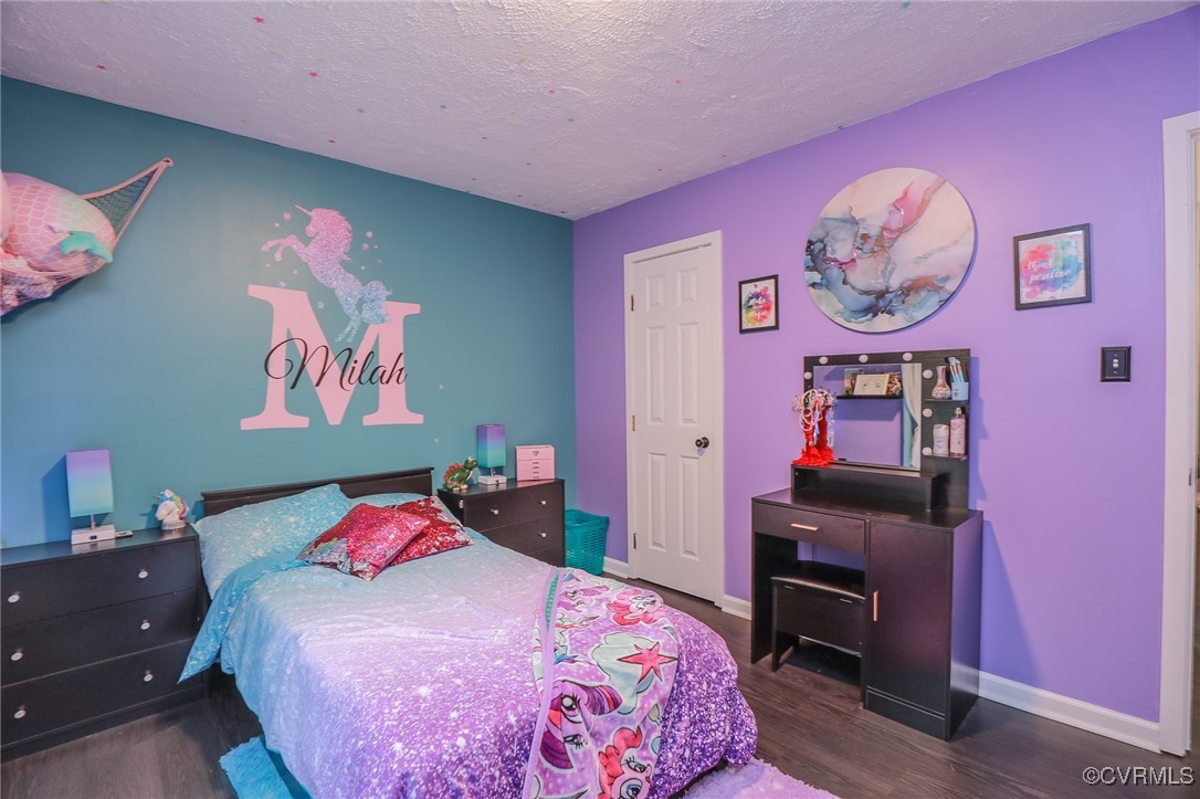 6812 Fairpines Road Chesterfield, VA 23832 - Photo 32 of 43 a bedroom with a bed a desk and paintings on the wall