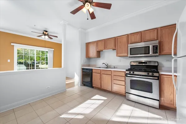 a kitchen with stainless steel appliances granite countertop a stove microwave and sink