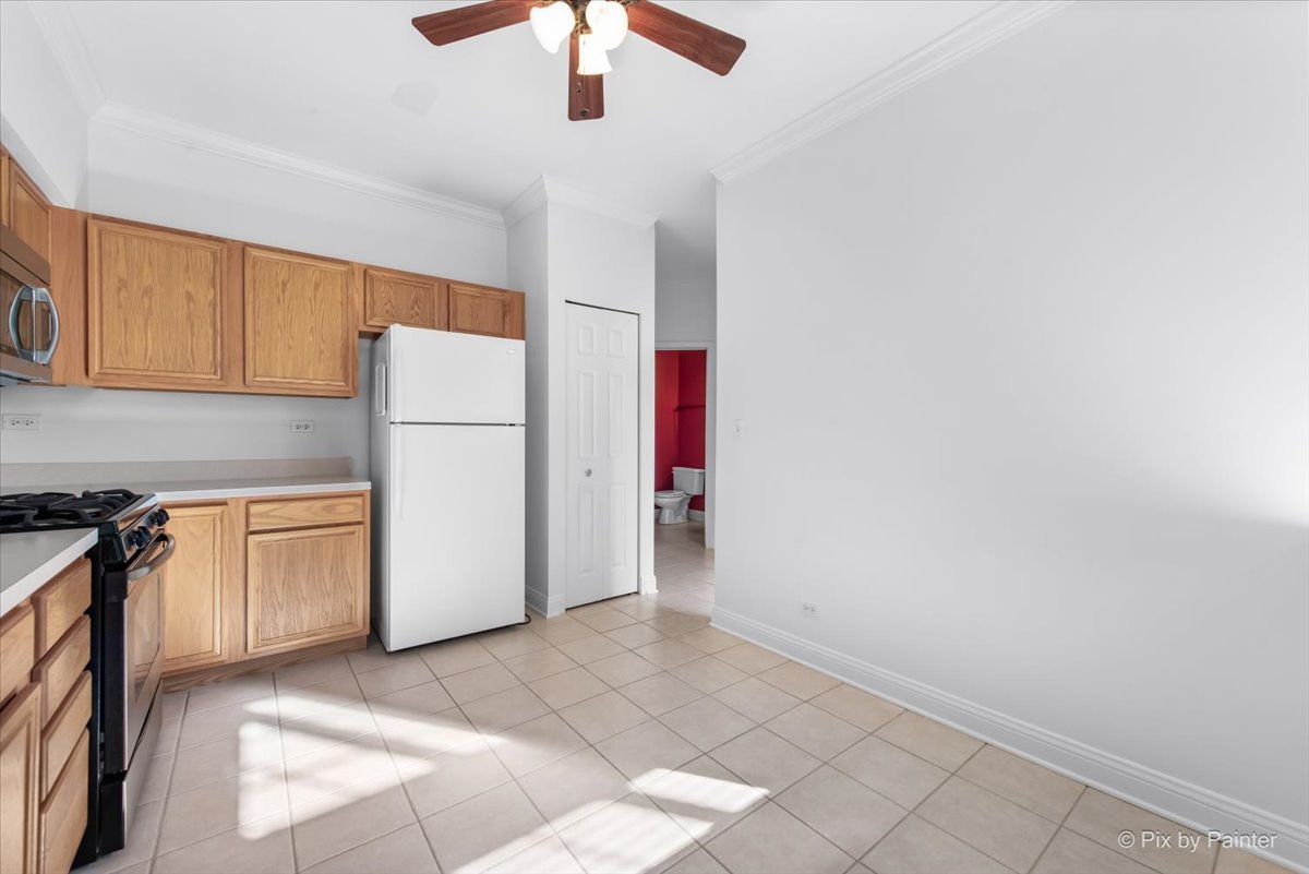 827 Riding Lane, Unit 827 St. Charles, IL 60174 - Photo 15 of 40 a kitchen with a refrigerator a stove top oven and cabinets