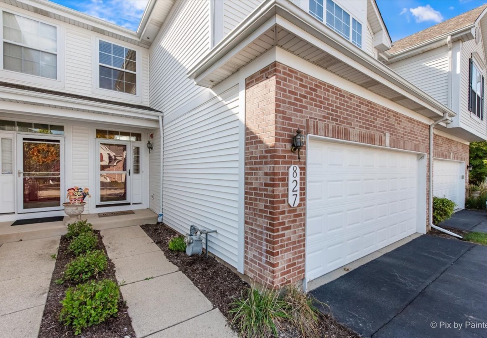 827 Riding Lane, Unit 827 St. Charles, IL 60174 - Photo 2 of 40 a front view of a house with garden
