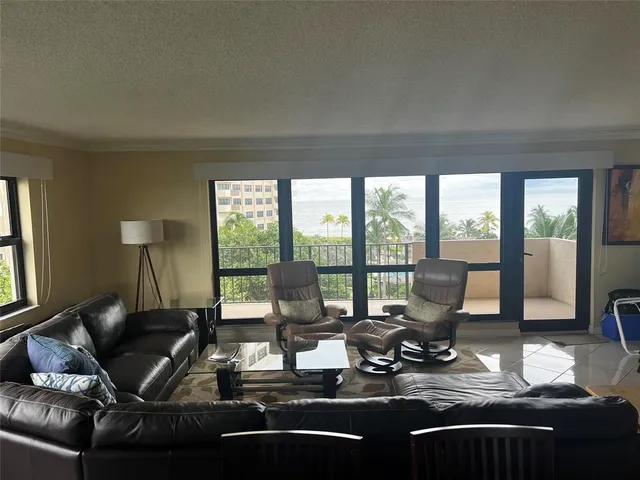 a room with a large window and a table chair