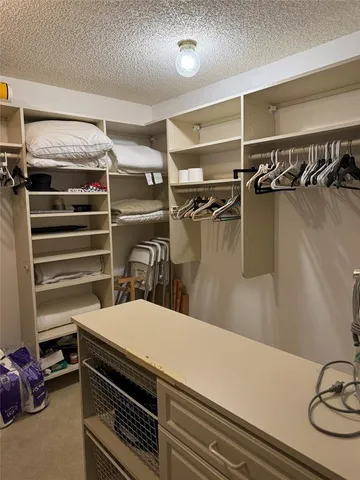 a bathroom with a granite countertop sink a toilet a mirror and bathtub