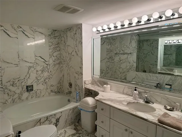 a bathroom with a shower and a sink