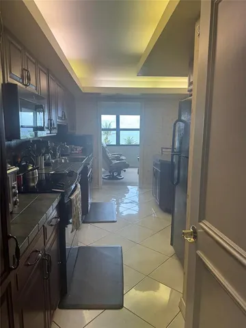 a living room with furniture and a gym machine