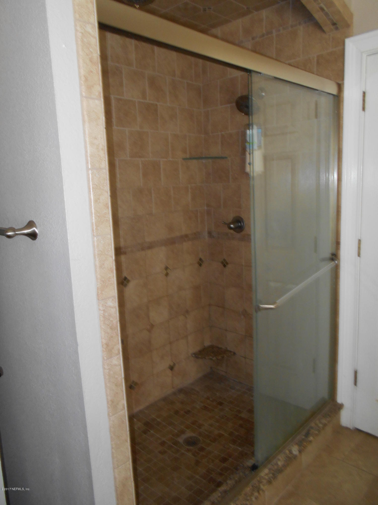 3006 Holly Road Orange Park, FL 32065 - Photo 13 of 19 a bathroom with a glass shower door