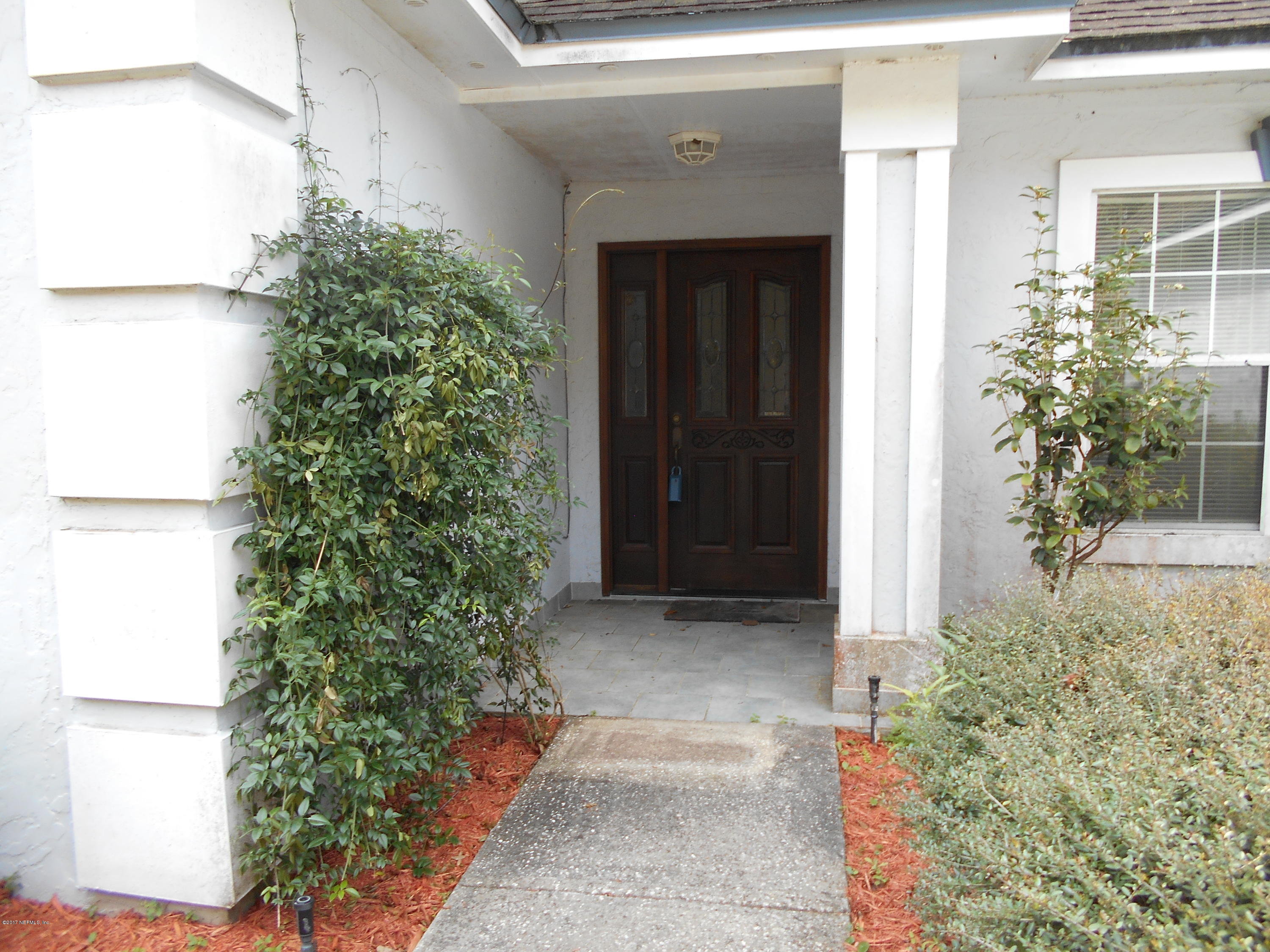 3006 Holly Road Orange Park, FL 32065 - Photo 2 of 19 a couple of potted plants in front of door
