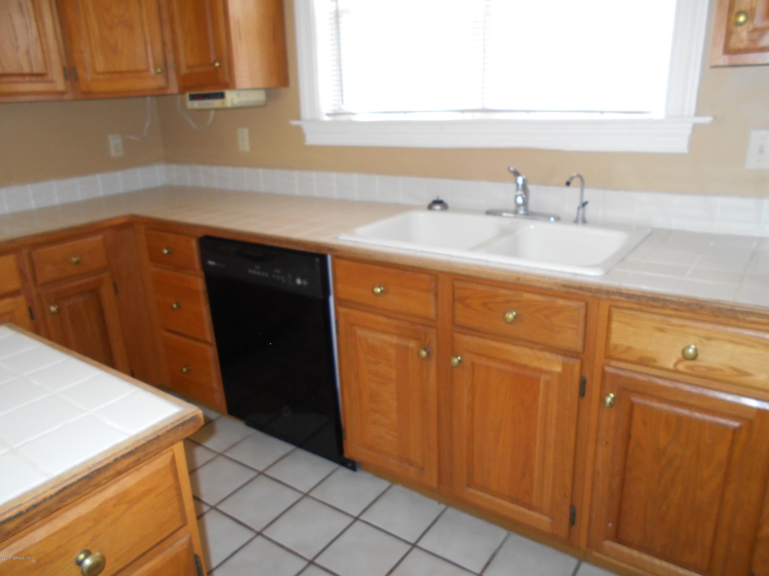 3006 Holly Road Orange Park, FL 32065 - Photo 6 of 19 a kitchen with a sink and cabinets