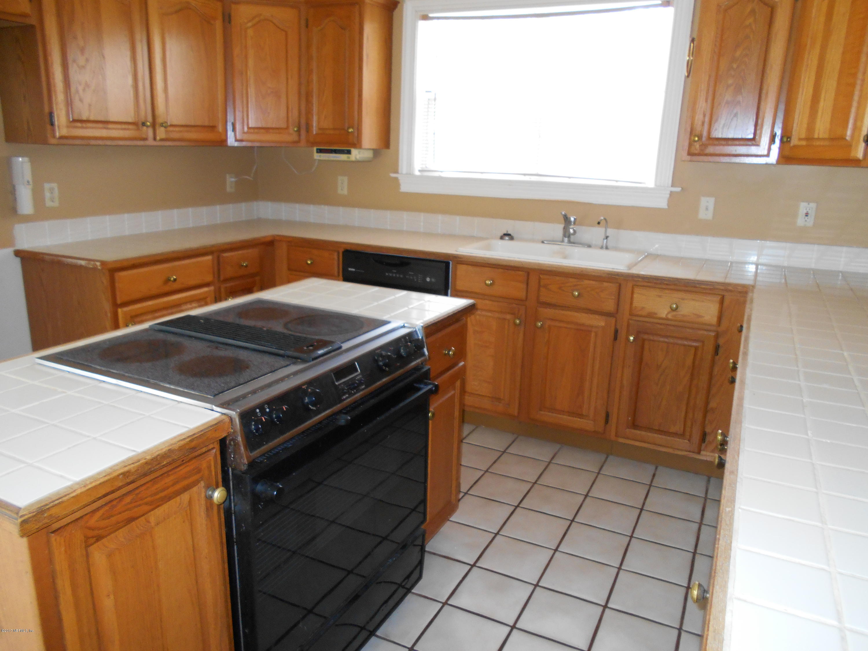 3006 Holly Road Orange Park, FL 32065 - Photo 7 of 19 a kitchen with a sink stove and cabinets